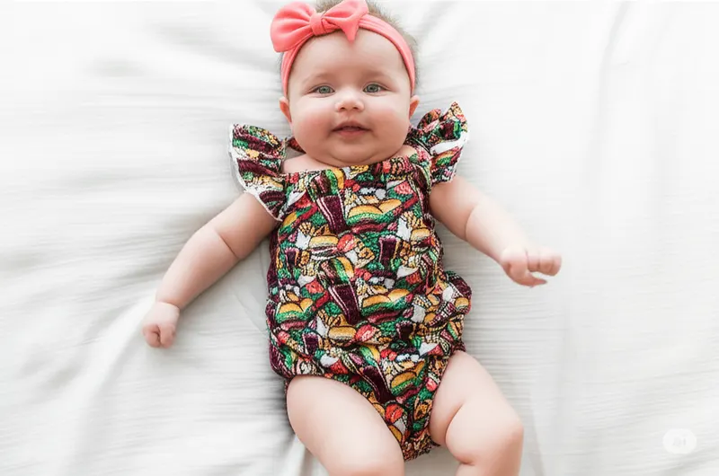 Girls bamboo romper with hamburger print, flutter sleeves and ruffle butt detail