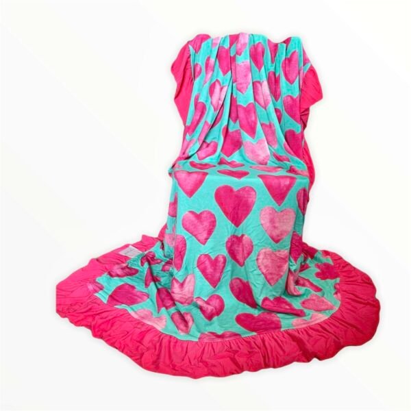 Reversible bamboo blanket showing ice cream floral print and pink hearts print with ruffle border